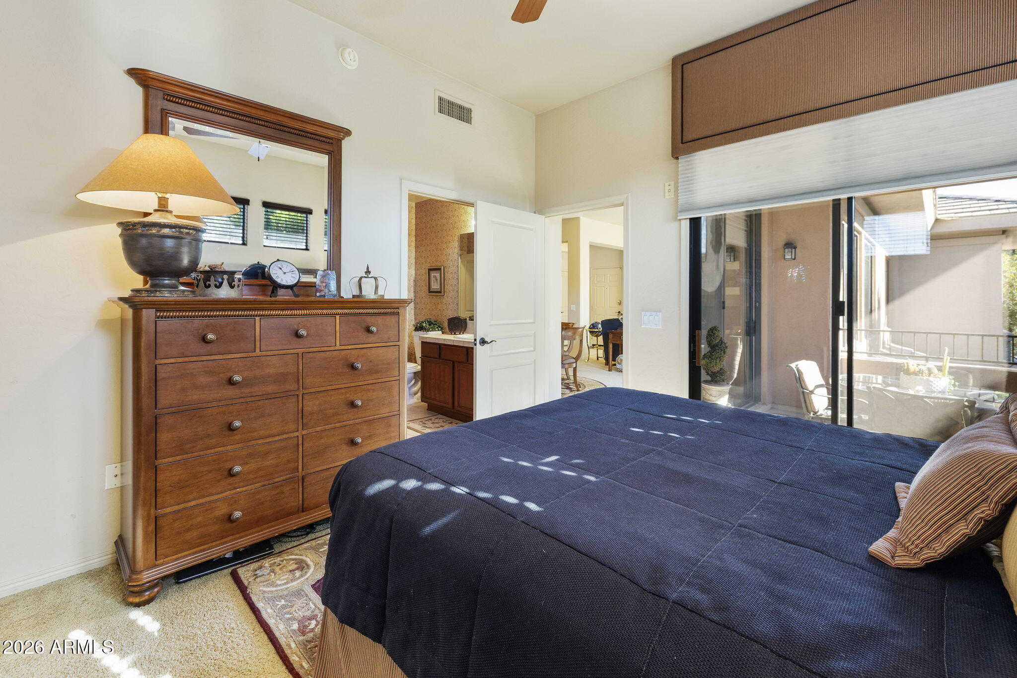 2989 North 44th Street, Unit 3018 Phoenix, AZ 85018 - Photo 29 of 45 a bedroom with a bed and wooden floor