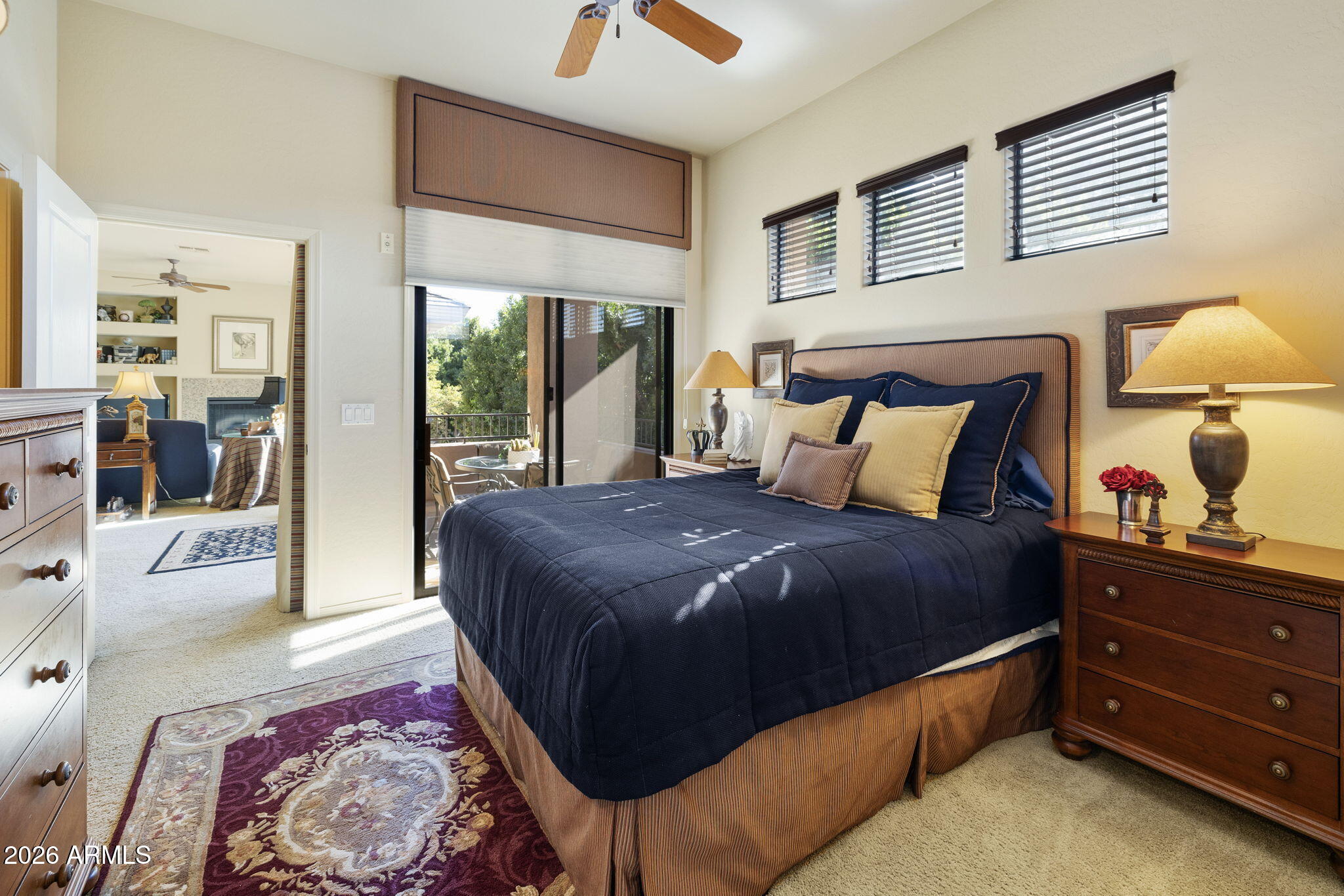 2989 North 44th Street, Unit 3018 Phoenix, AZ 85018 - Photo 30 of 45 a bedroom with a large bed and a lamp on dresser