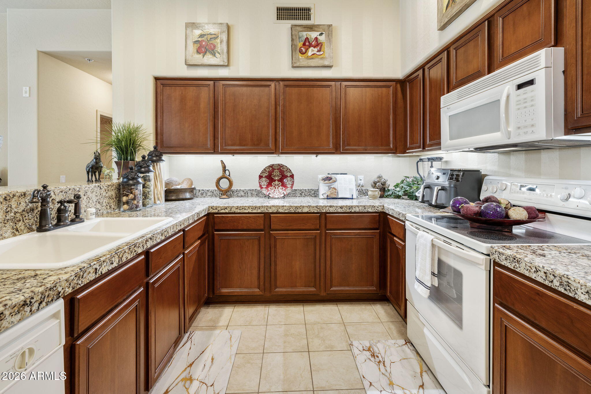 2989 North 44th Street, Unit 3018 Phoenix, AZ 85018 - Photo 3 of 43 a kitchen with a sink stove and cabinets