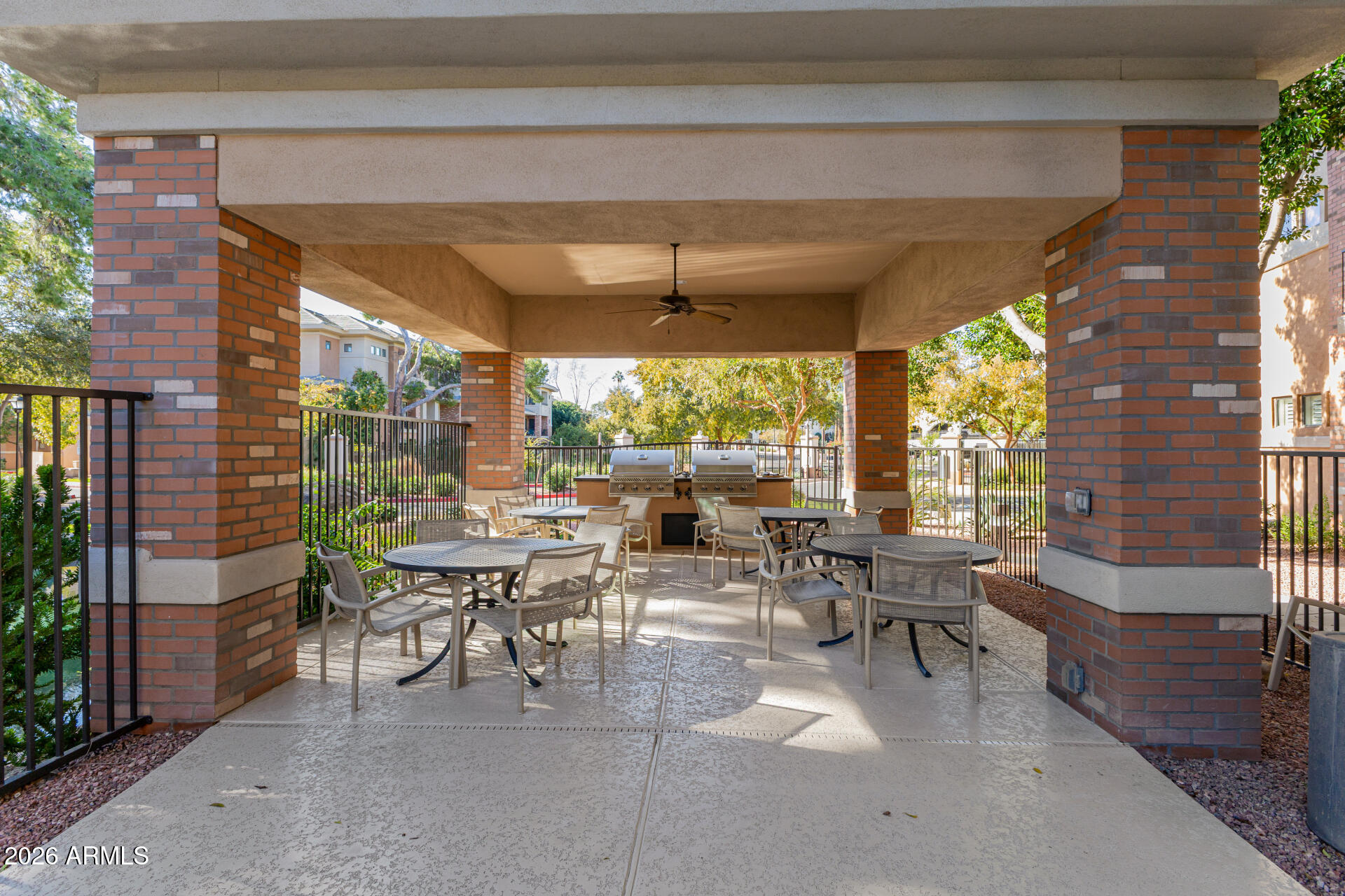 2989 North 44th Street, Unit 3018 Phoenix, AZ 85018 - Photo 33 of 43 a view of a patio with table and chairs potted plants and floor to ceiling window