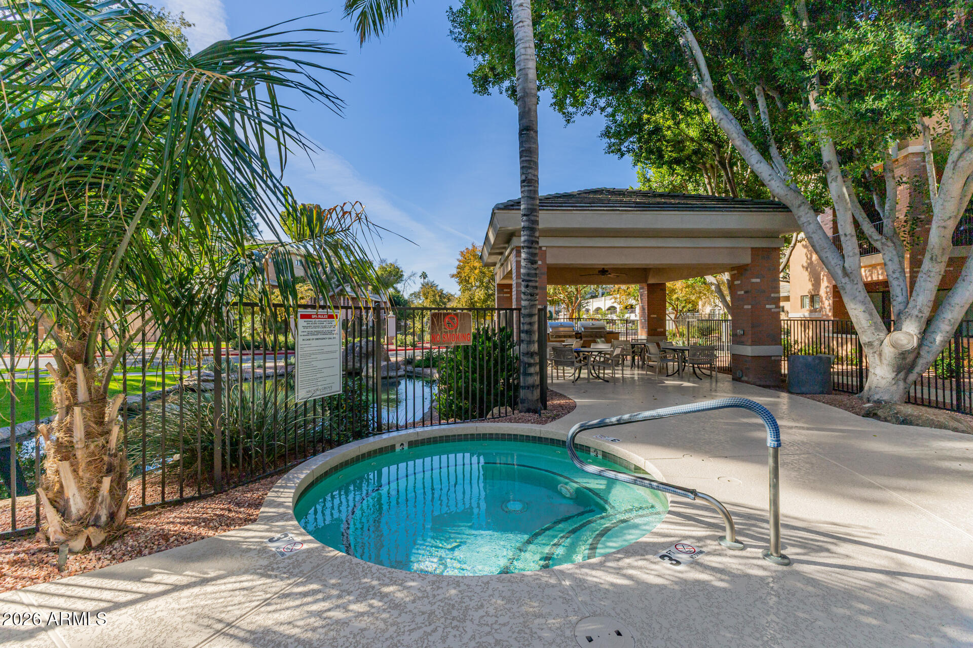 2989 North 44th Street, Unit 3018 Phoenix, AZ 85018 - Photo 34 of 45 a swimming pool with outdoor seating and yard
