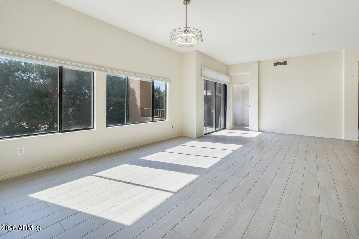 2989 North 44th Street, Unit 3018 Phoenix, AZ 85018 - Photo 5 of 45 a view of a room with wooden floor and balcony