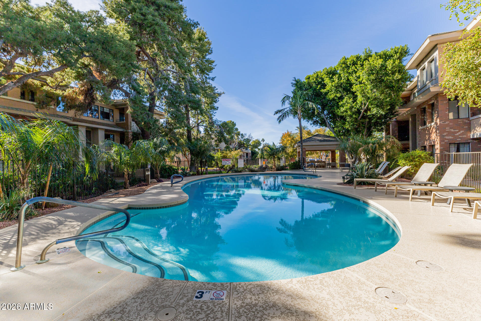 2989 North 44th Street, Unit 3018 Phoenix, AZ 85018 - Photo 6 of 45 a view of a swimming pool with lounge chair