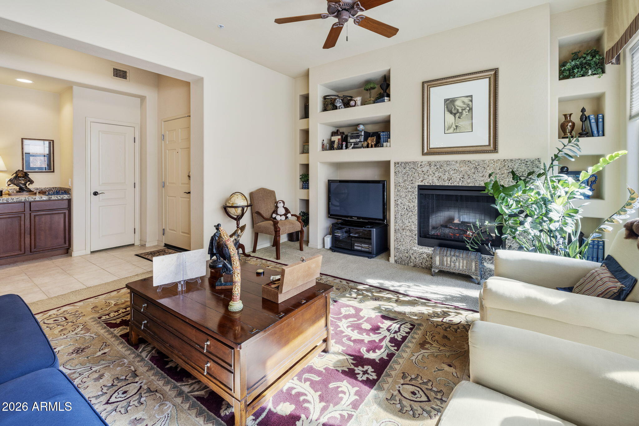 2989 North 44th Street, Unit 3018 Phoenix, AZ 85018 - Photo 10 of 43 a living room with furniture and a fireplace