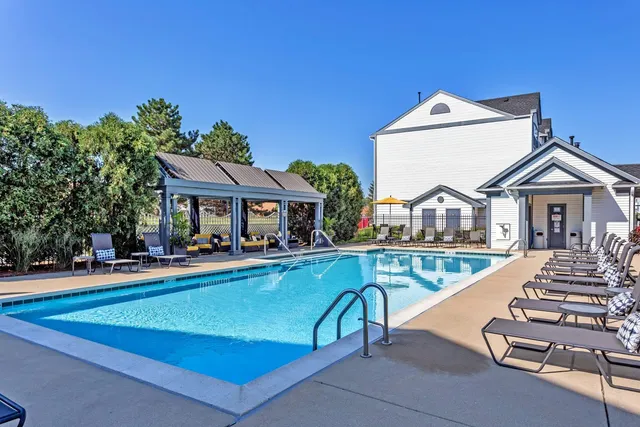 a view of a house with swimming pool and sitting area