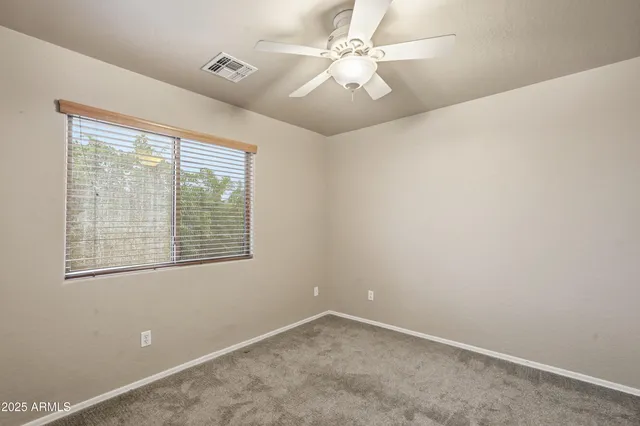 a view of a garden with a building in the background