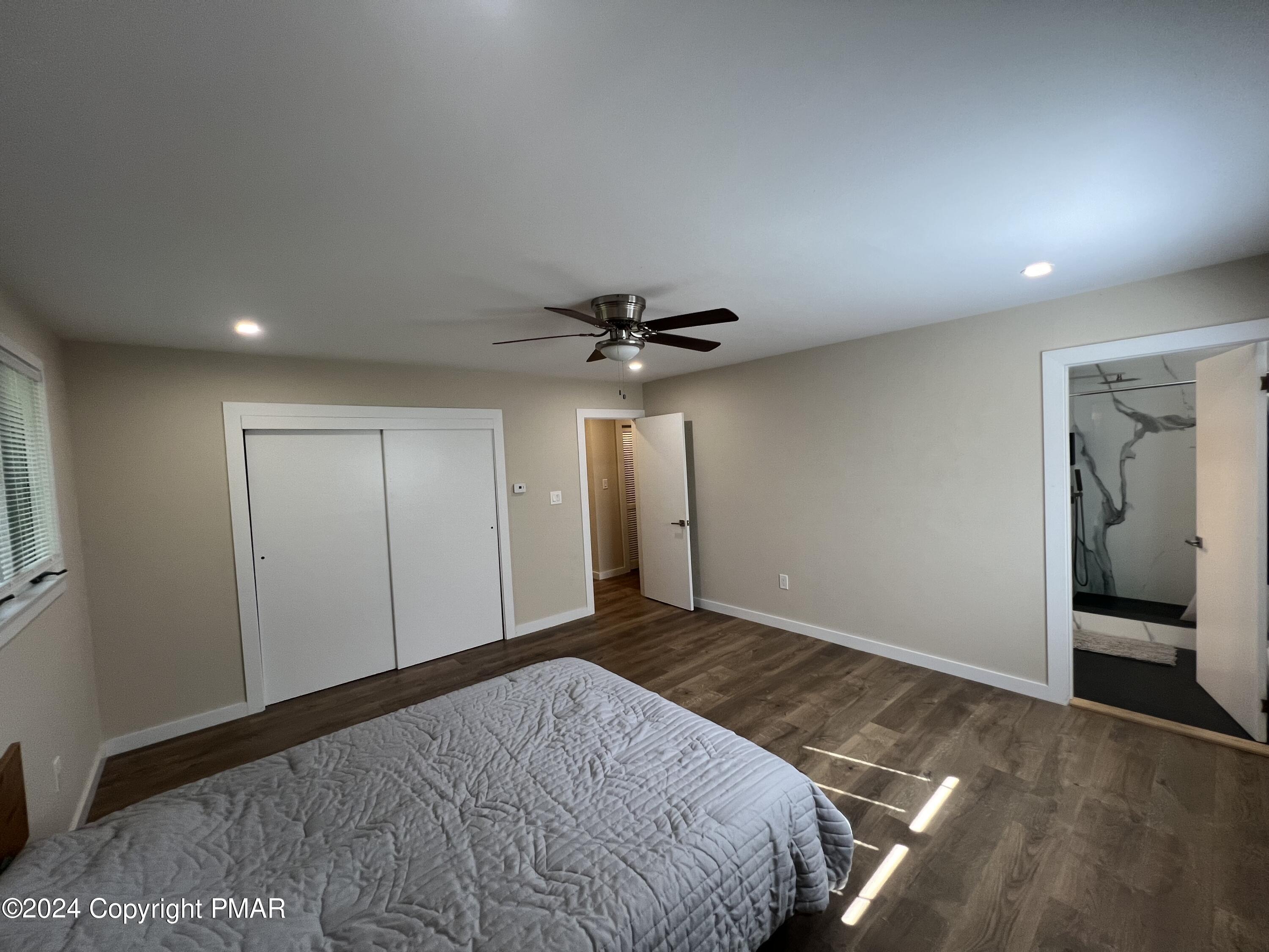 83 Balson Road Stroudsburg, PA 18360 - Photo 20 of 37 a bedroom with a bed and a chandelier