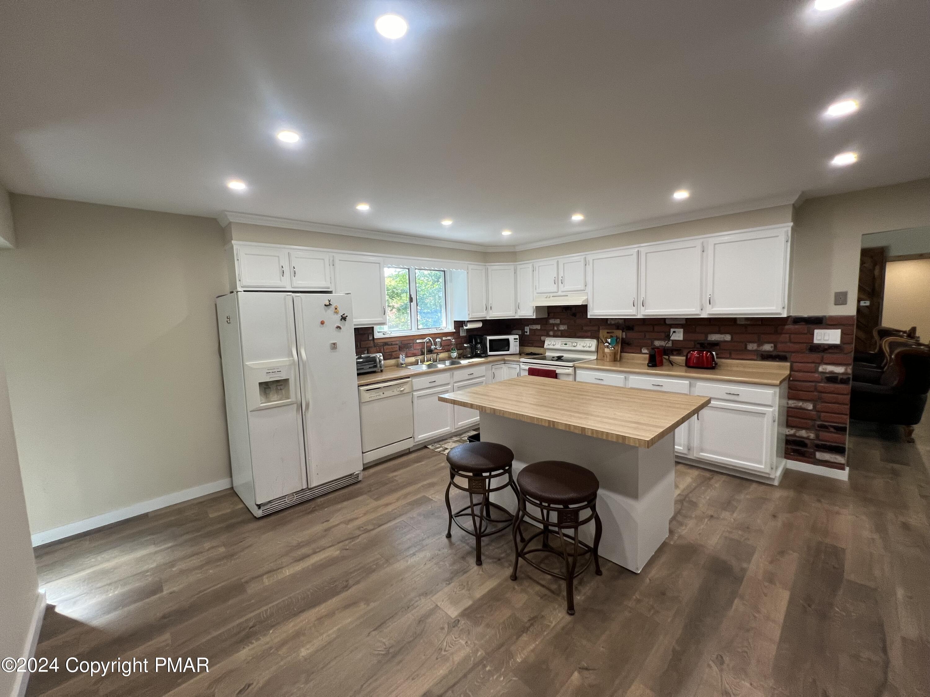 83 Balson Road Stroudsburg, PA 18360 - Photo 9 of 37 a kitchen with refrigerator and chairs