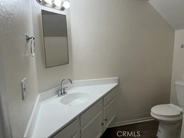 a bathroom with a sink toilet and vanity