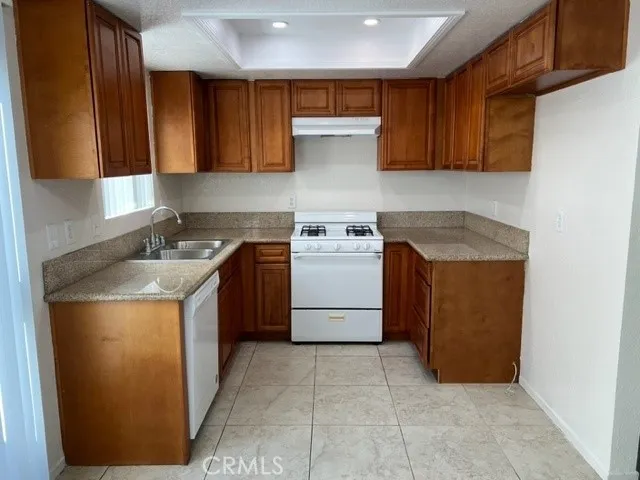 a kitchen with a stove sink and cabinets