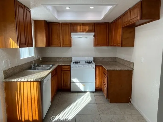 a kitchen with a stove top oven sink and cabinets