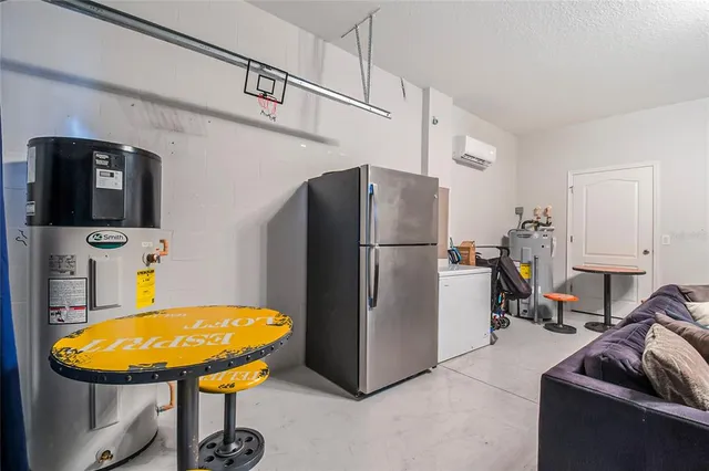 a view of a kitchen with kitchen island granite countertop a refrigerator stove top oven with a sink and dishwasher