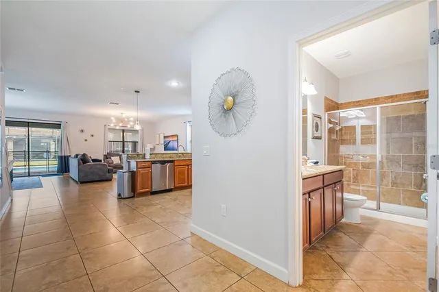 a living room with furniture kitchen and a chandelier