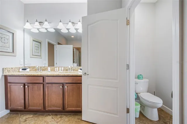 a bedroom with a bed a dresser and a flat screen tv