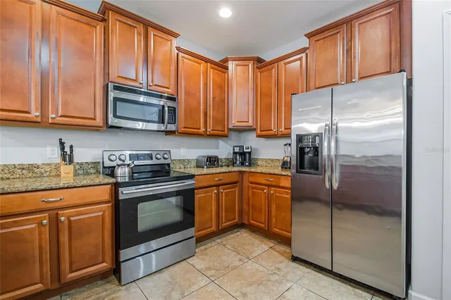 a spacious bathroom with a granite countertop sink a toilet and a mirror