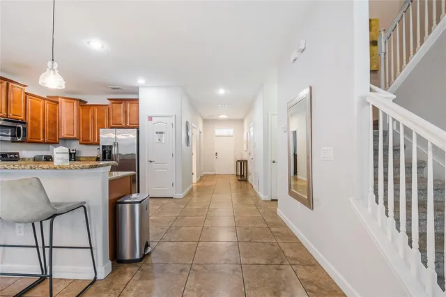 a large bedroom with a bed and a chandelier