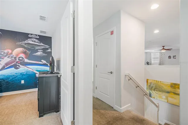 an aerial view of a house with swimming pool and wooden fence