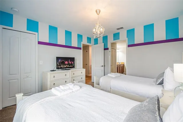 an aerial view of residential houses with outdoor space and parking