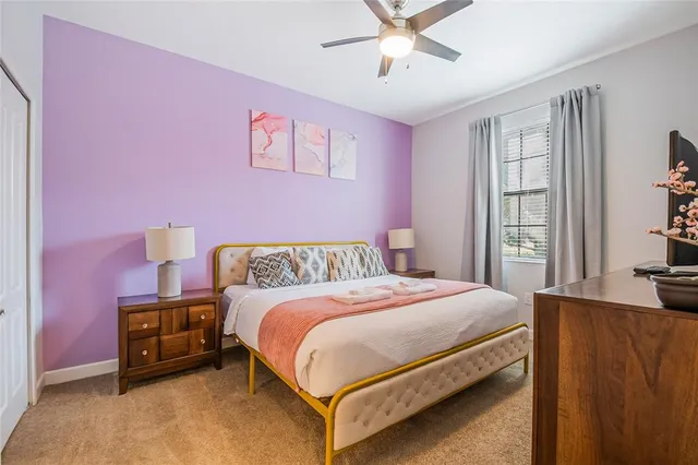 a bathroom with a granite countertop sink a toilet and a mirror