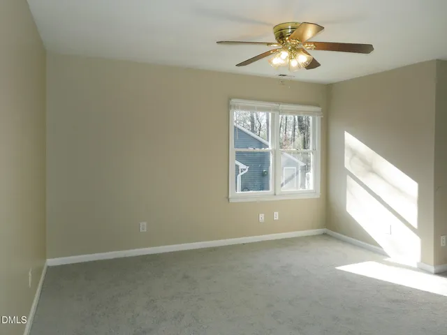 a bathroom with a toilet and a window