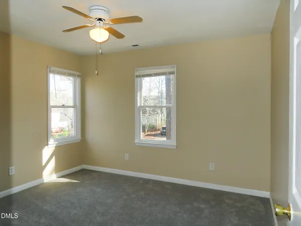an empty room with windows and closet