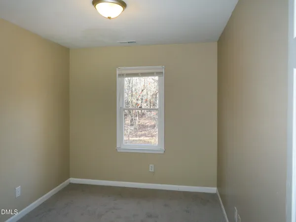 a bathroom with a toilet sink and window