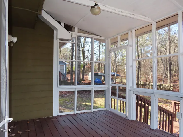 a view of a wooden fence and trees