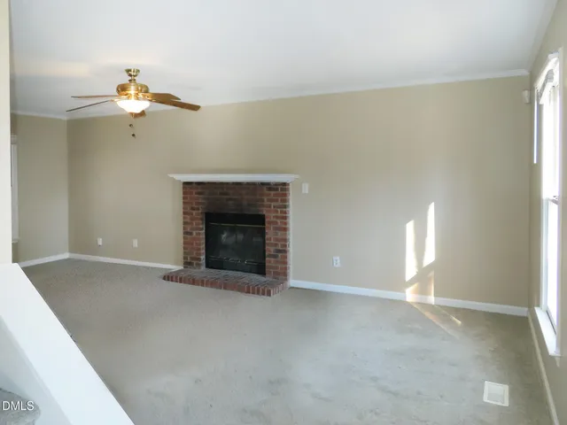 a view of empty room with a fireplace