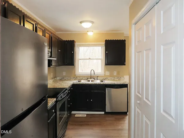 a kitchen with granite countertop a sink and cabinets