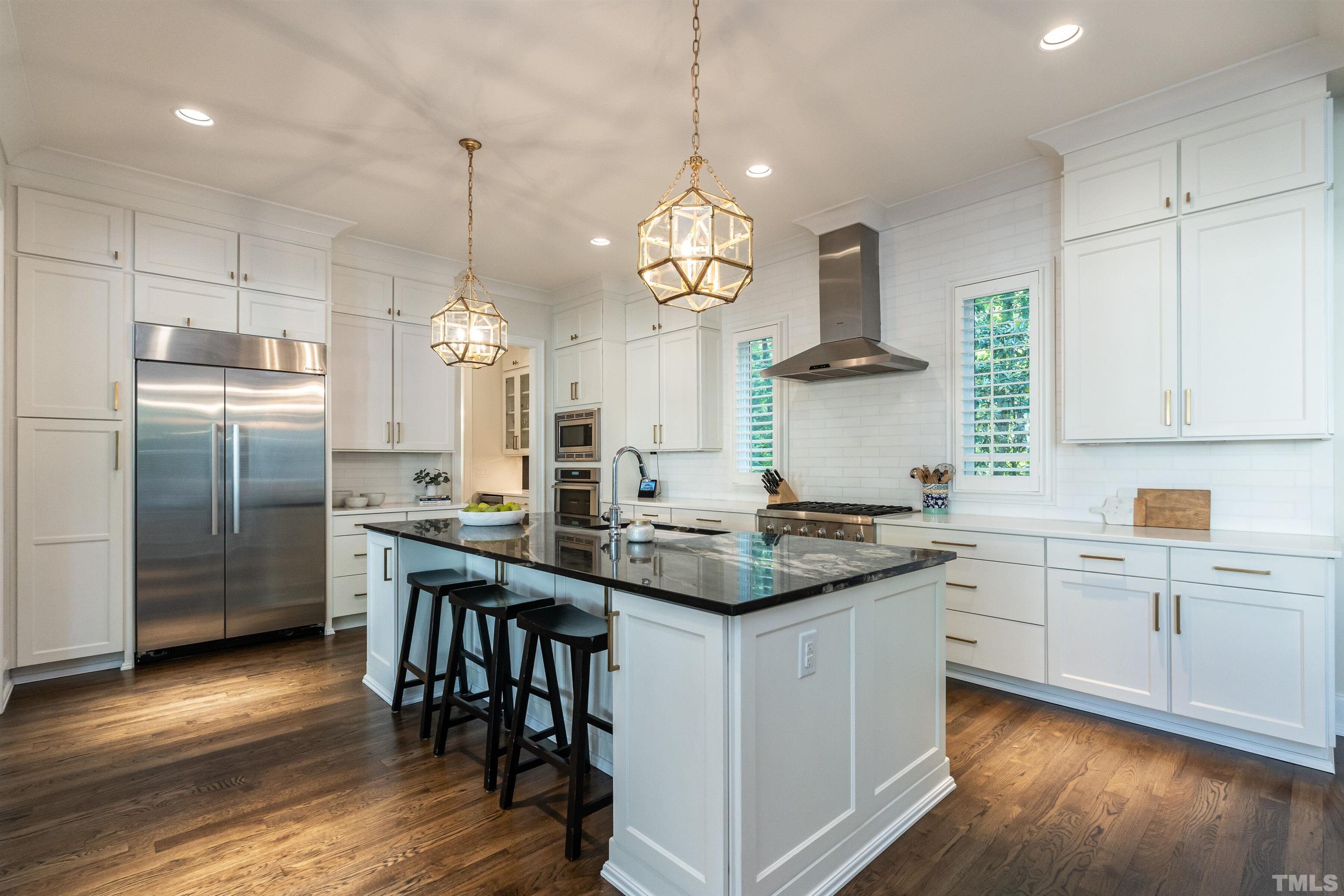 3403 Ocotea Street Raleigh, NC 27607 - Photo 11 of 46 a kitchen with stainless steel appliances granite countertop a sink a stove and a refrigerator