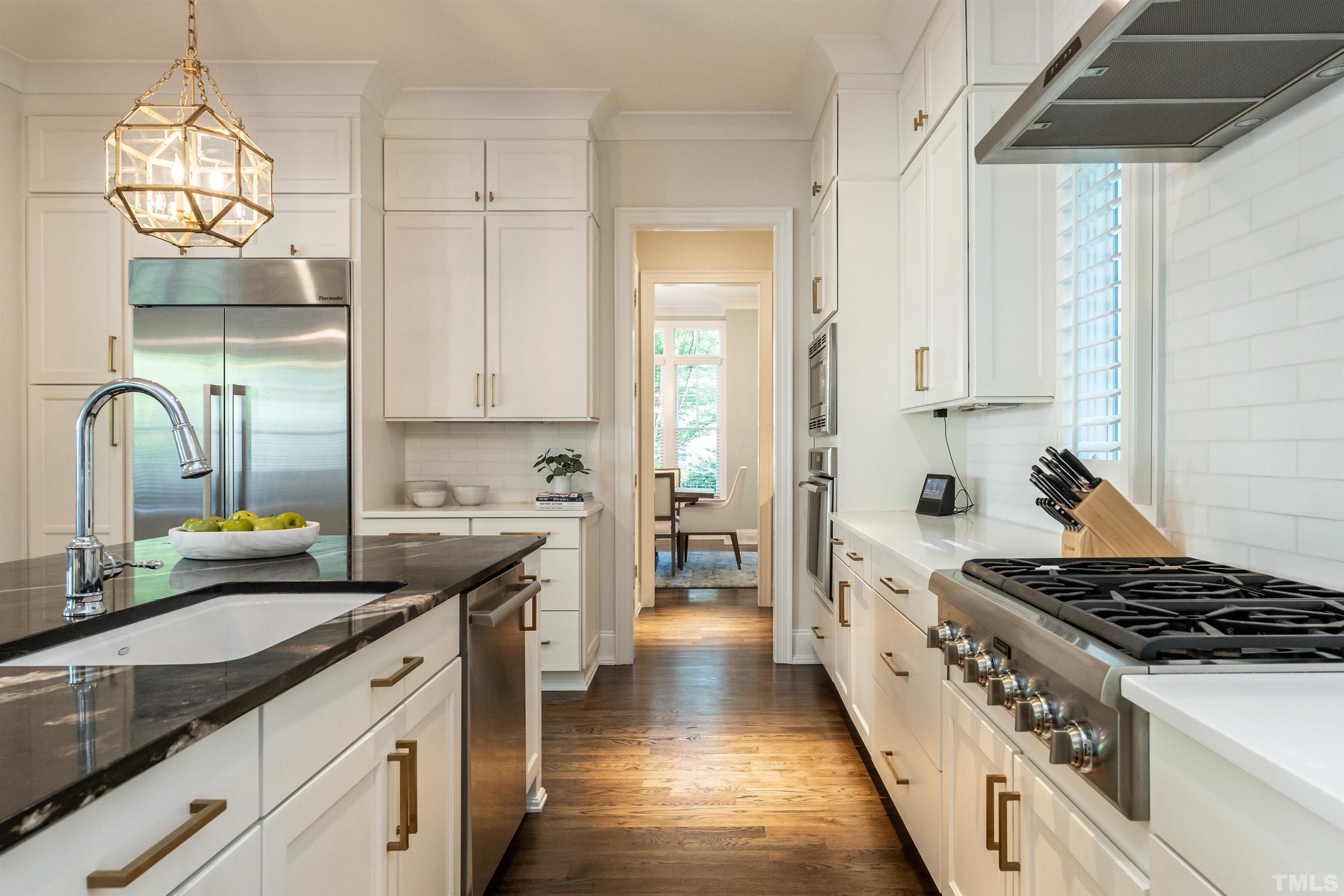 3403 Ocotea Street Raleigh, NC 27607 - Photo 13 of 46 a kitchen with a sink stove and cabinets