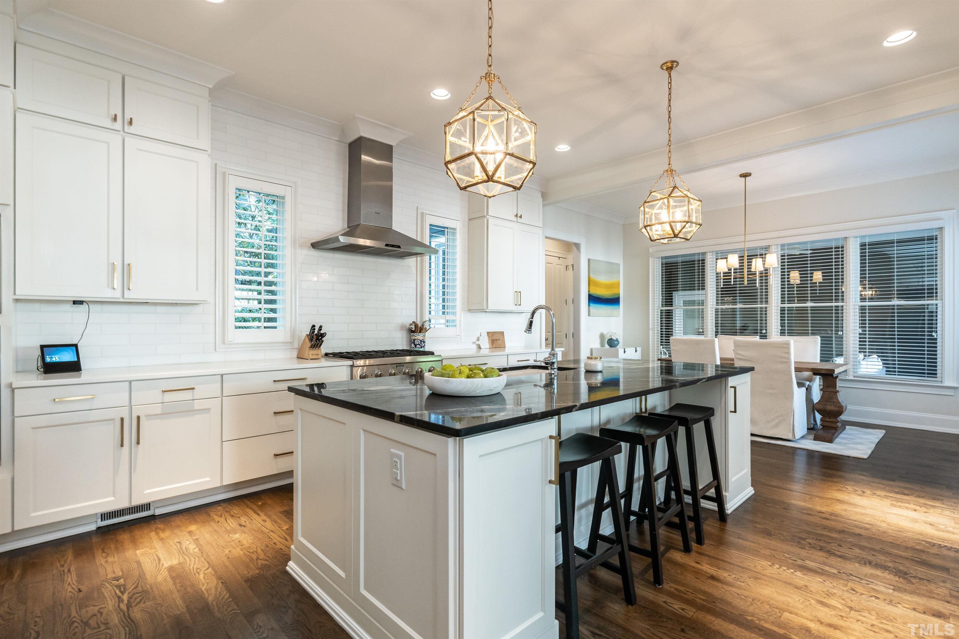 3403 Ocotea Street Raleigh, NC 27607 - Photo 16 of 46 a kitchen with lots of counter space and dining table