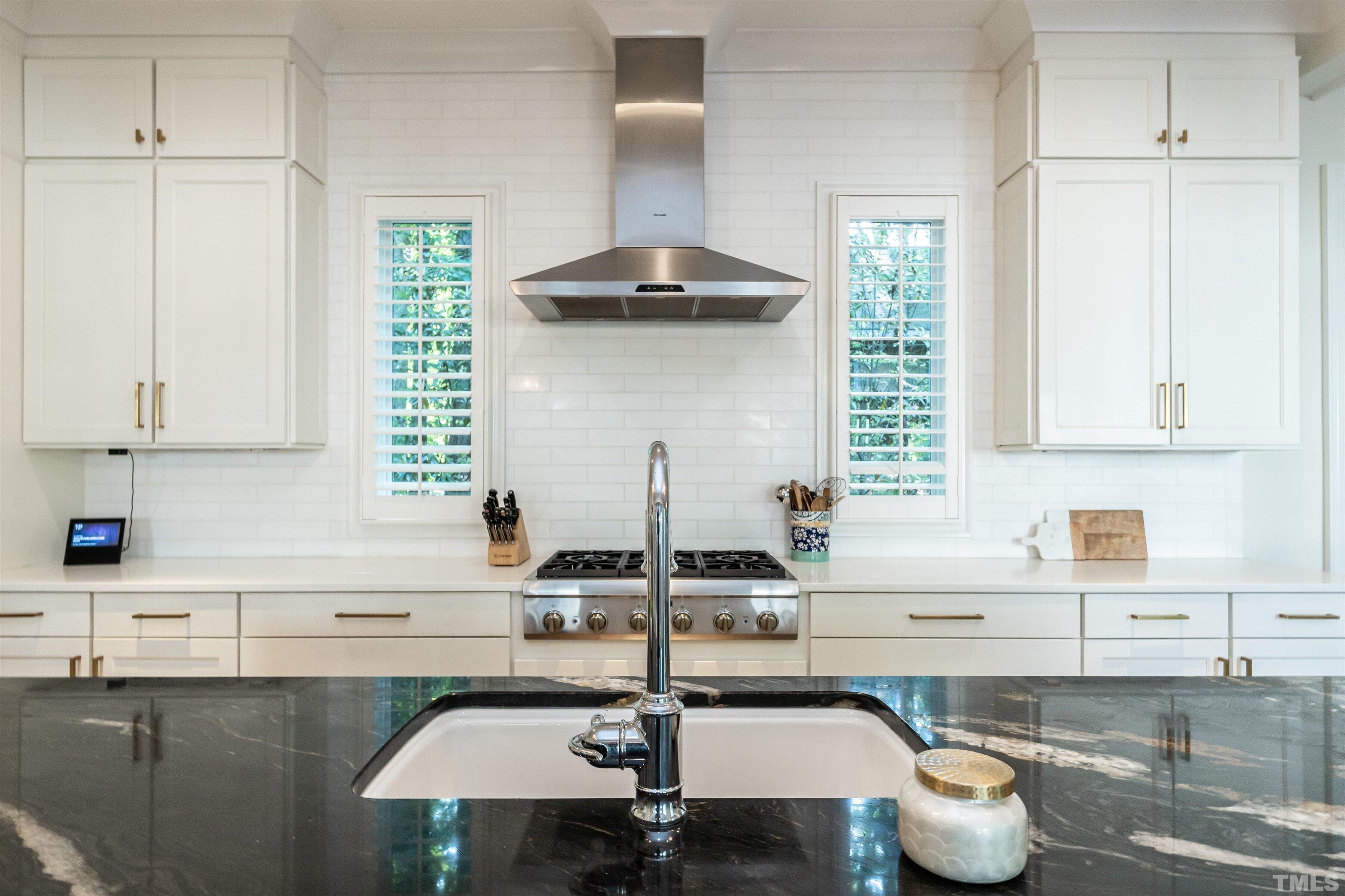 3403 Ocotea Street Raleigh, NC 27607 - Photo 17 of 46 a kitchen with a sink and cabinets