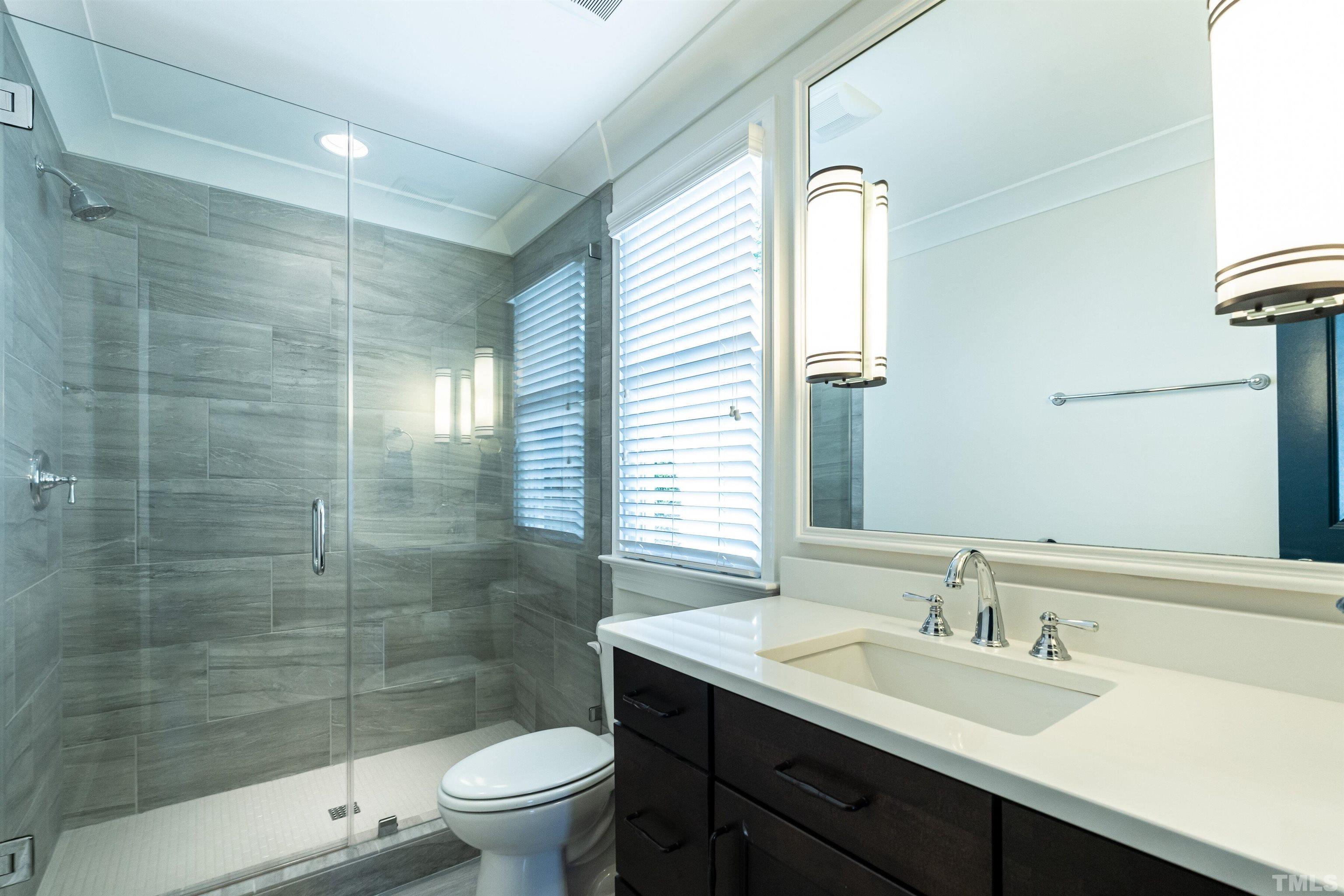 3403 Ocotea Street Raleigh, NC 27607 - Photo 21 of 46 a bathroom with a sink a toilet and shower