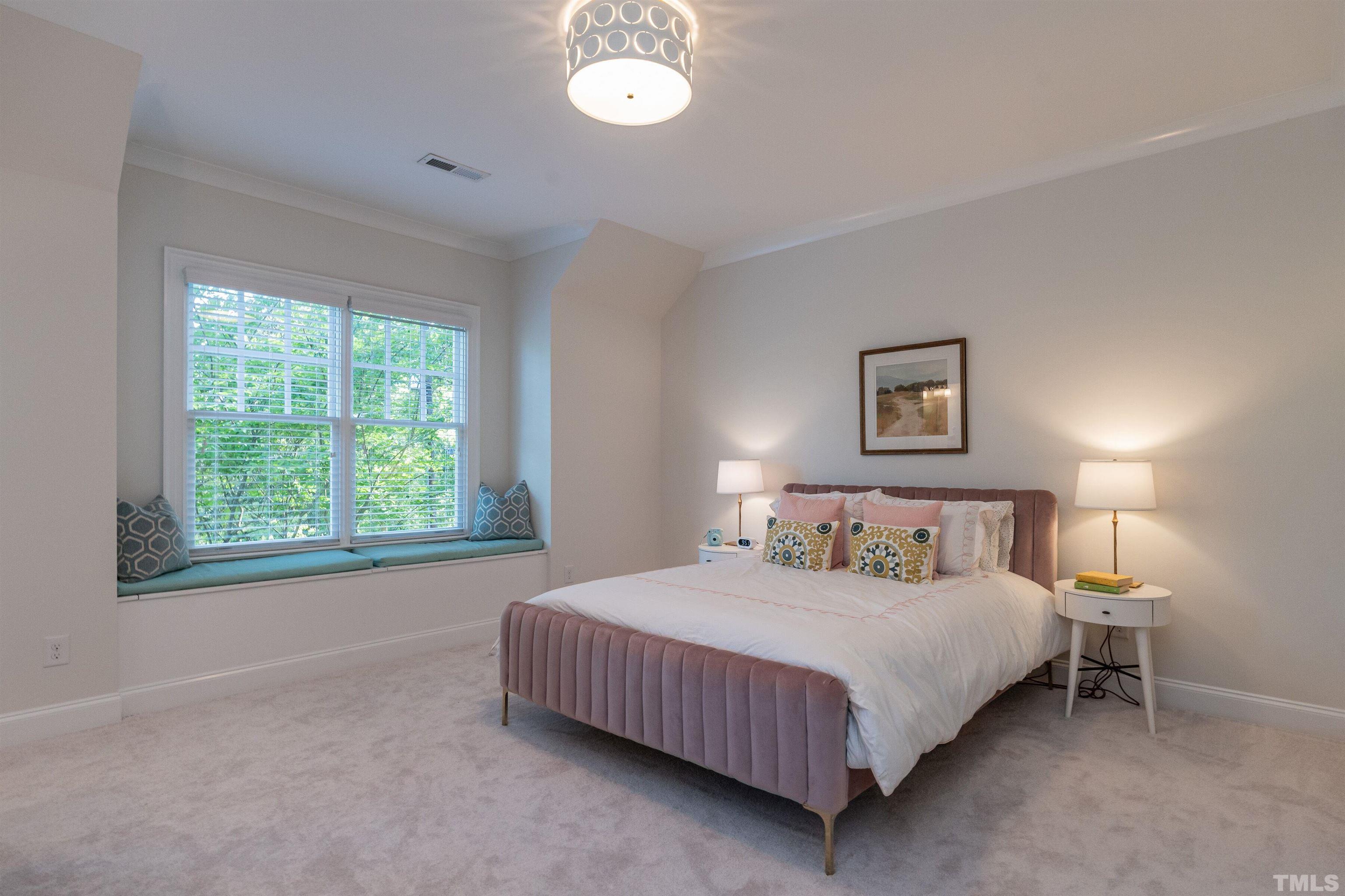 3403 Ocotea Street Raleigh, NC 27607 - Photo 25 of 46 a bedroom with a bed and a lamp next to a window
