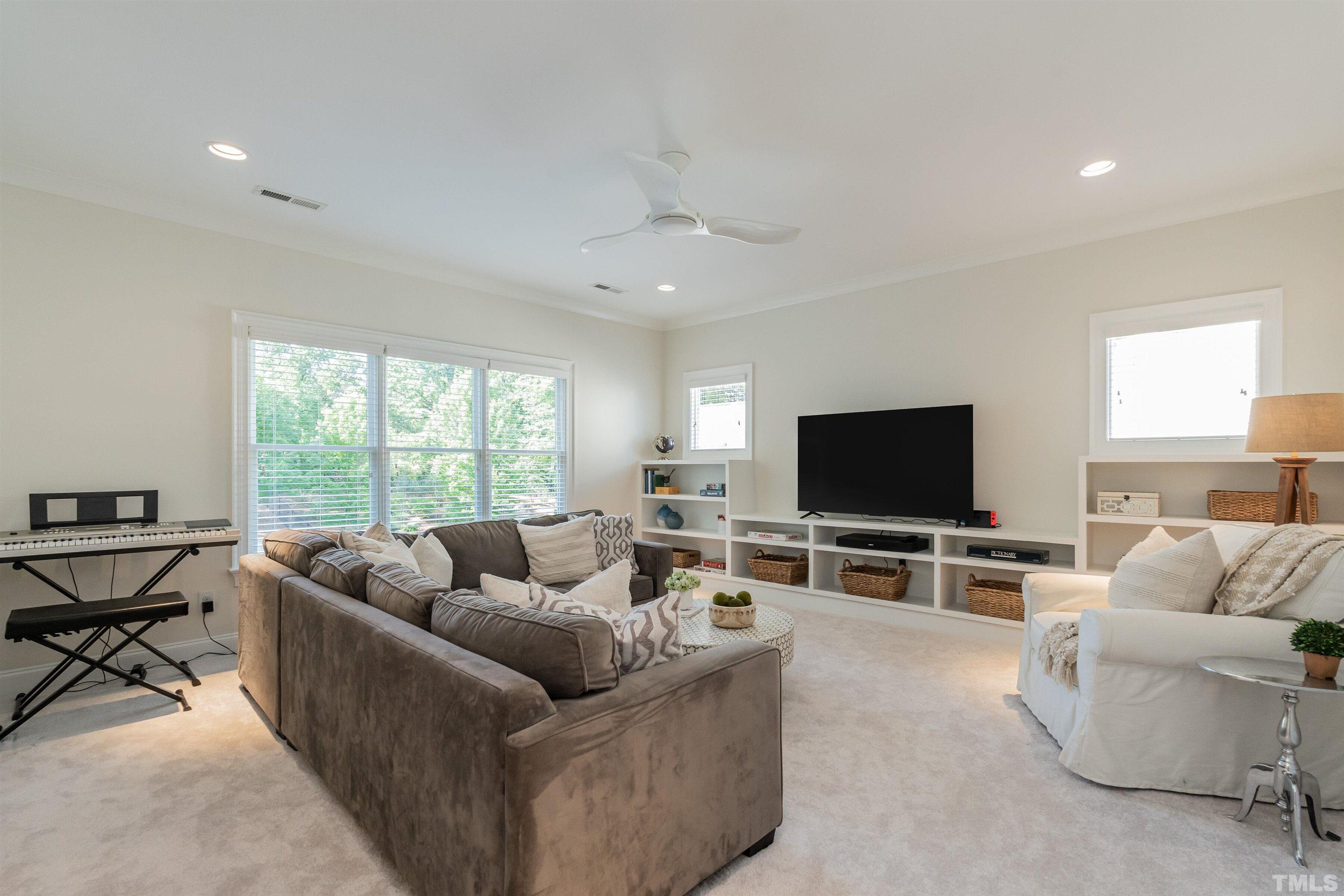 3403 Ocotea Street Raleigh, NC 27607 - Photo 27 of 46 a living room with furniture and a flat screen tv