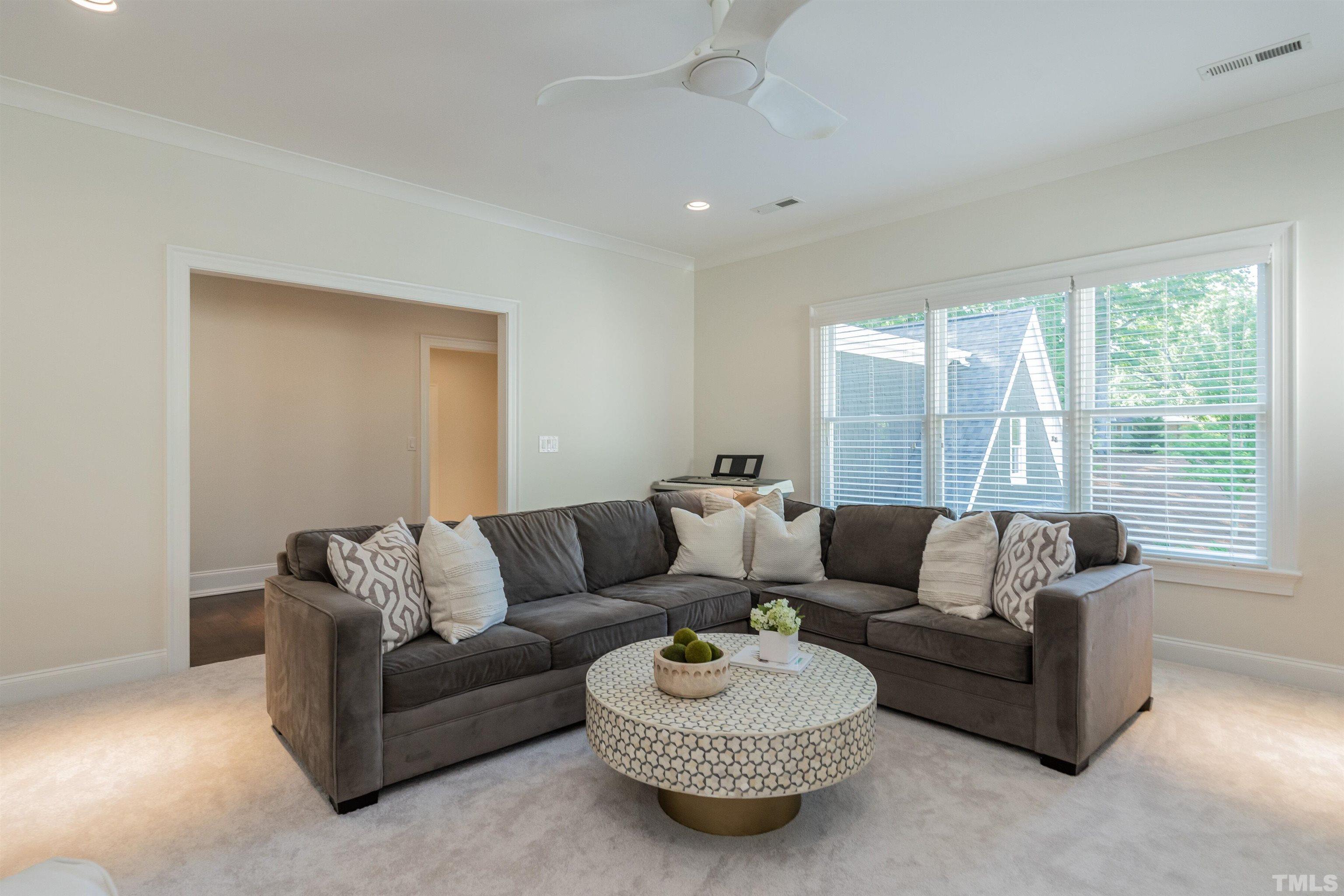 3403 Ocotea Street Raleigh, NC 27607 - Photo 28 of 46 a living room with furniture and a large window