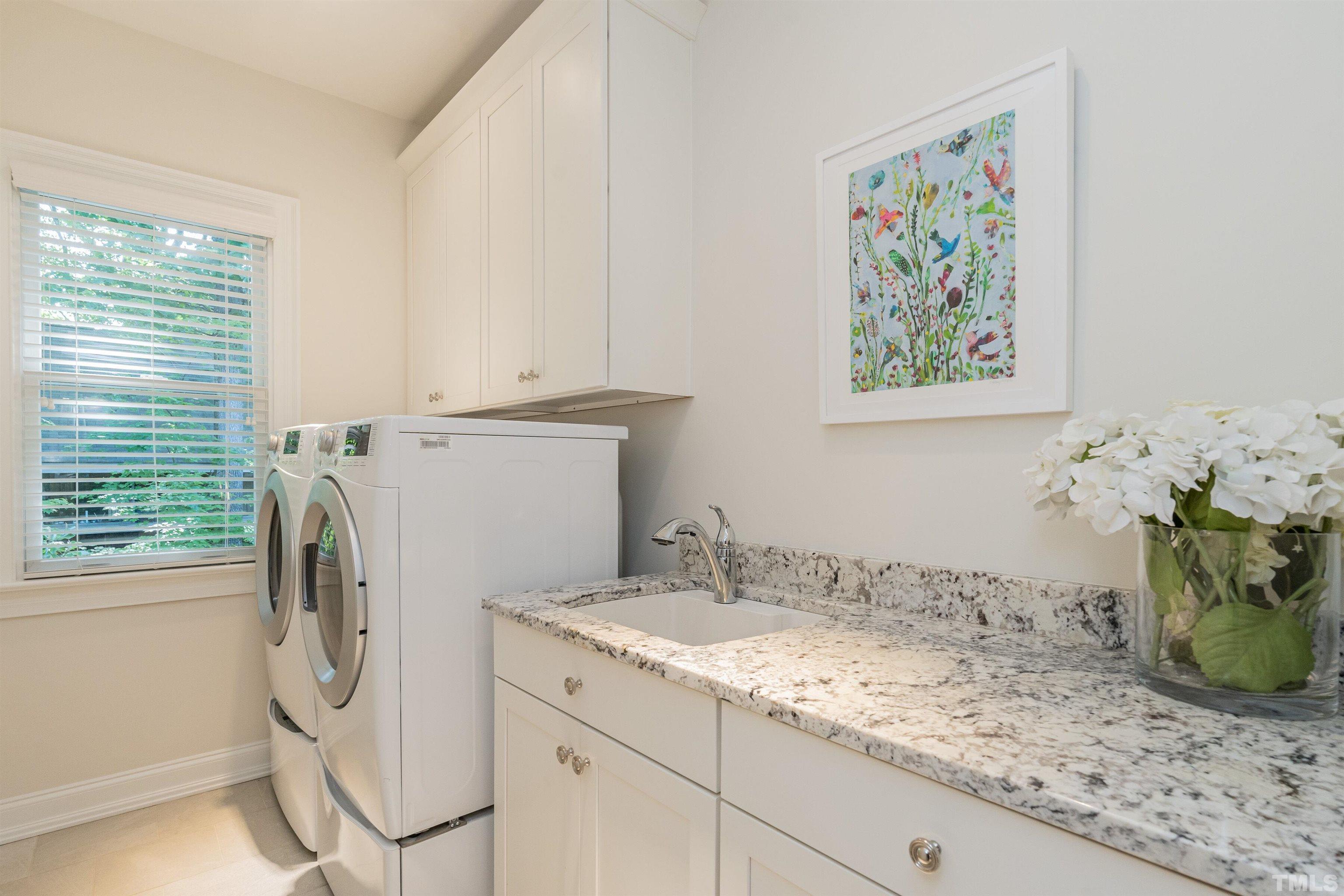3403 Ocotea Street Raleigh, NC 27607 - Photo 29 of 46 a utility room with cabinets washer and dryer