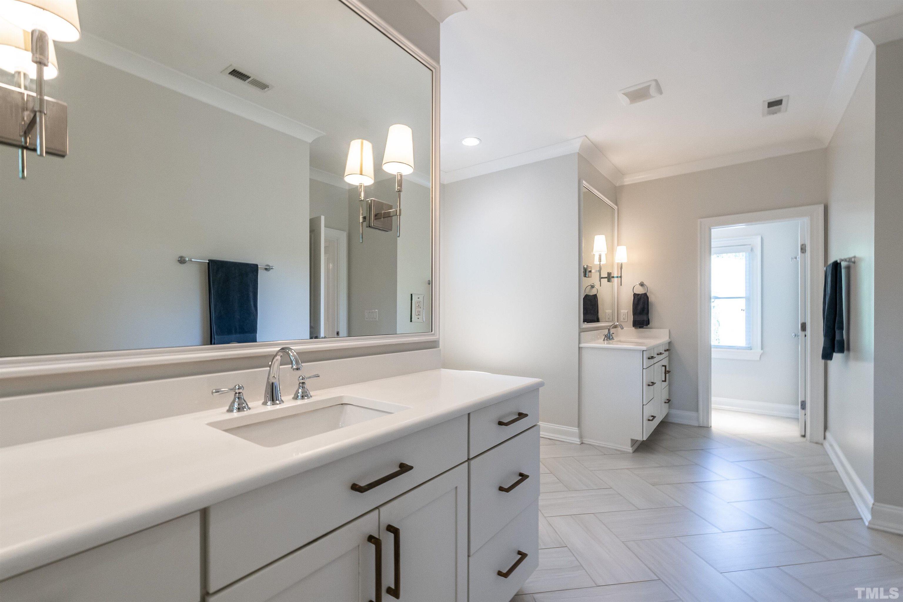3403 Ocotea Street Raleigh, NC 27607 - Photo 36 of 46 a spacious bathroom with a double vanity sink a mirror and a shower
