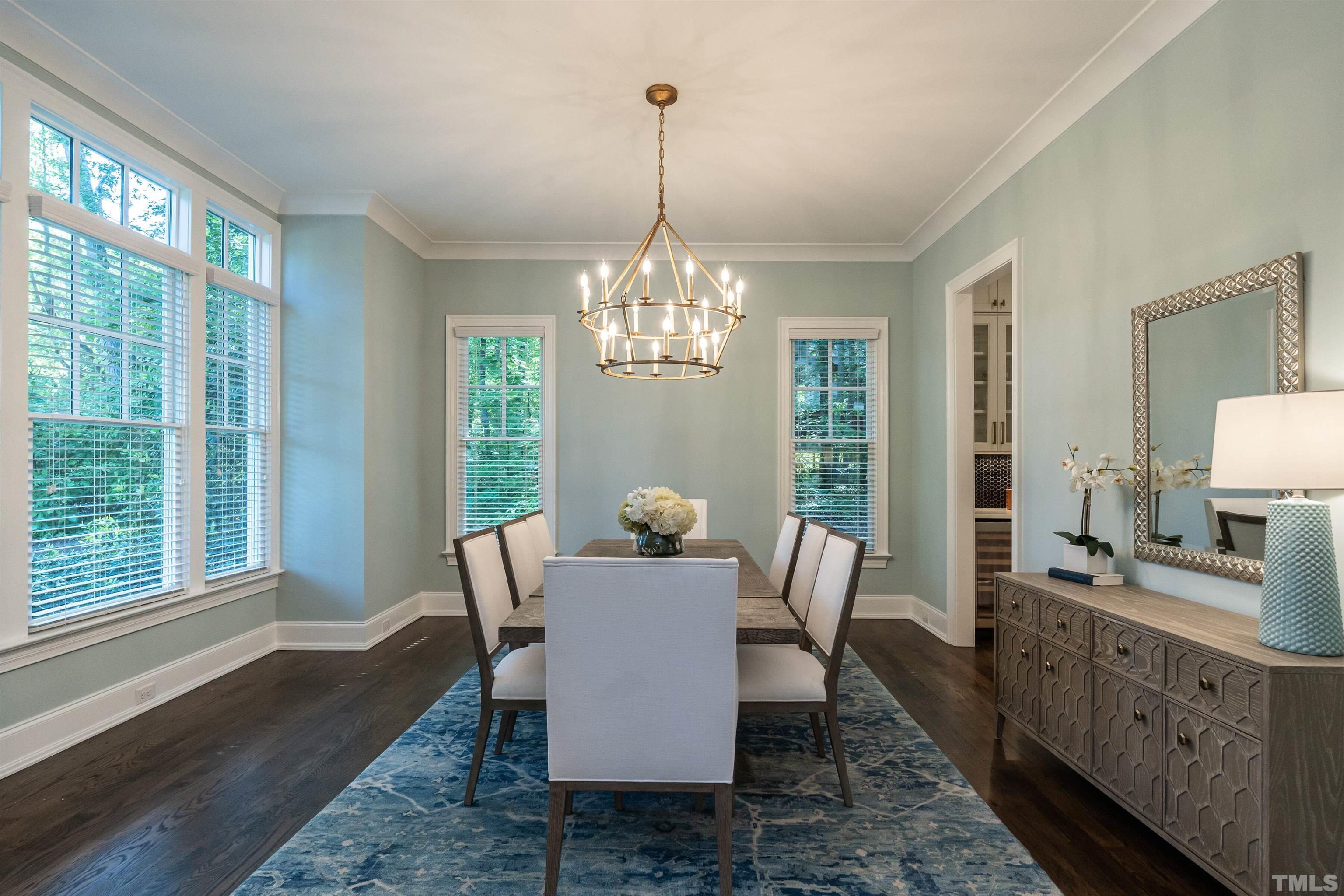 3403 Ocotea Street Raleigh, NC 27607 - Photo 4 of 46 a view of a dining room with furniture a chandelier and wooden floor