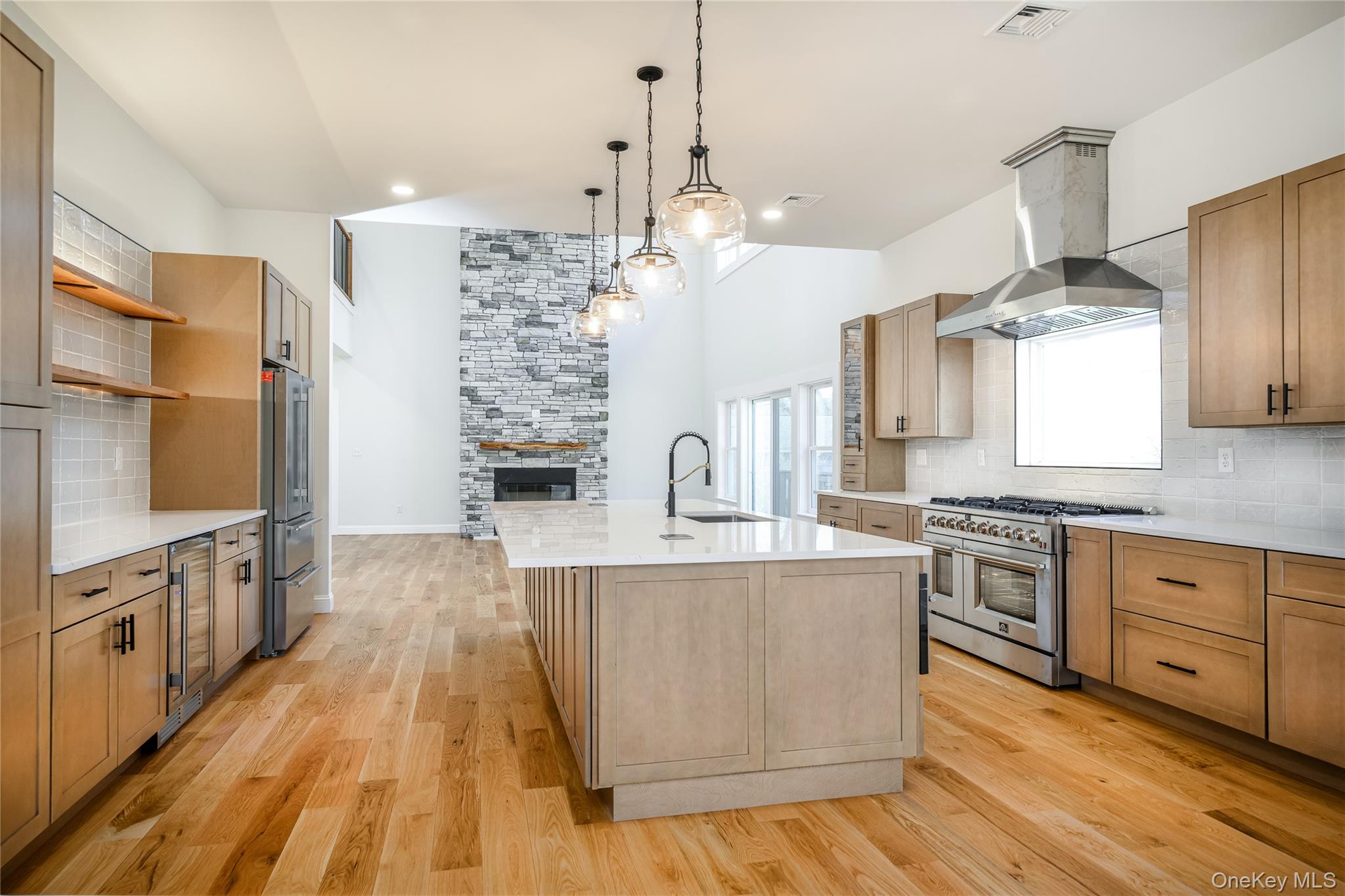 133 West Mombasha Road Monroe, NY 10950 - Photo 14 of 47 a large kitchen with stainless steel appliances granite countertop a stove and a wooden floors