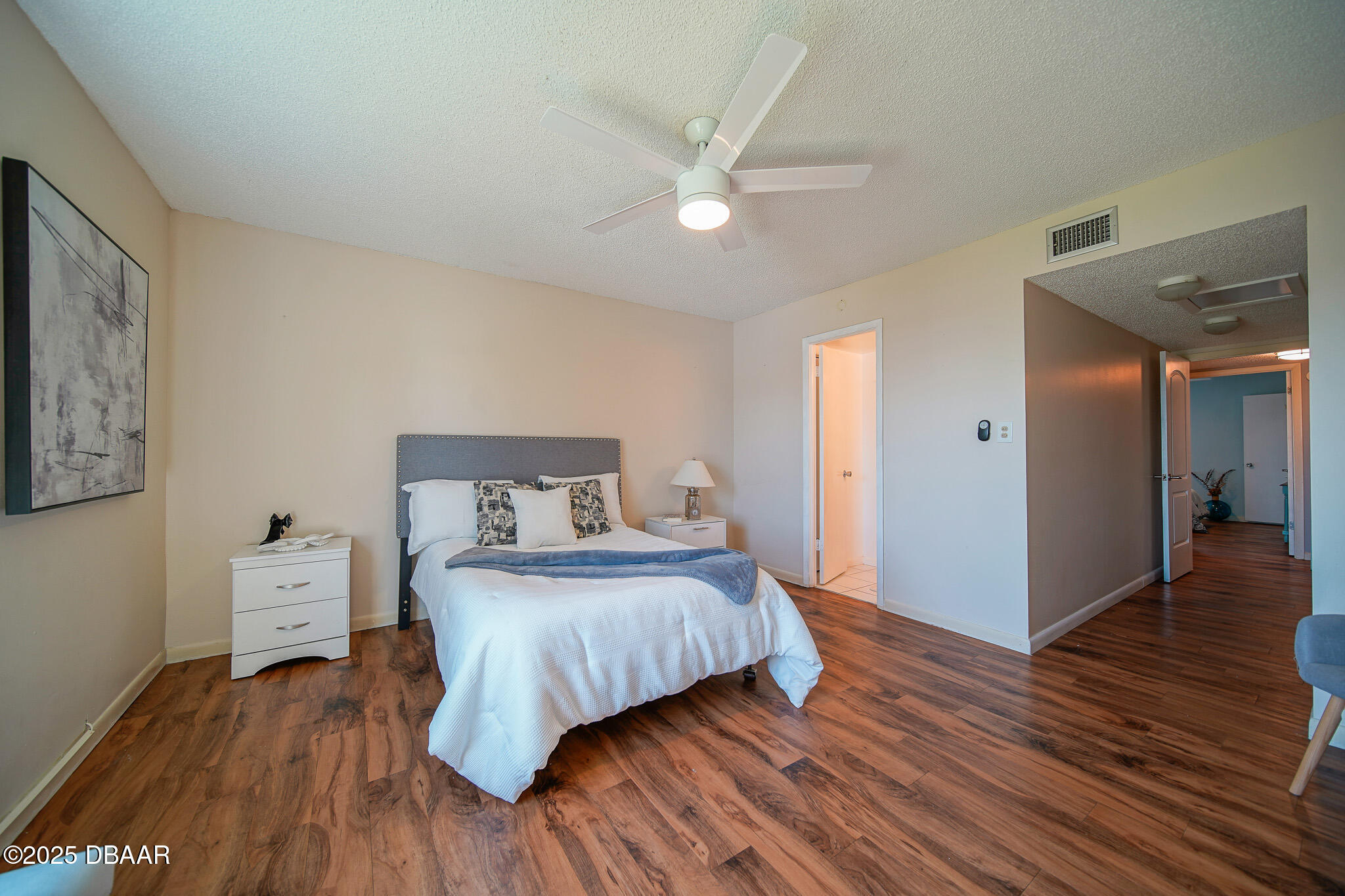 4590 South Atlantic Avenue, Unit 247 Ponce Inlet, FL 32127 - Photo 11 of 36 a bedroom with a bed and wooden floor