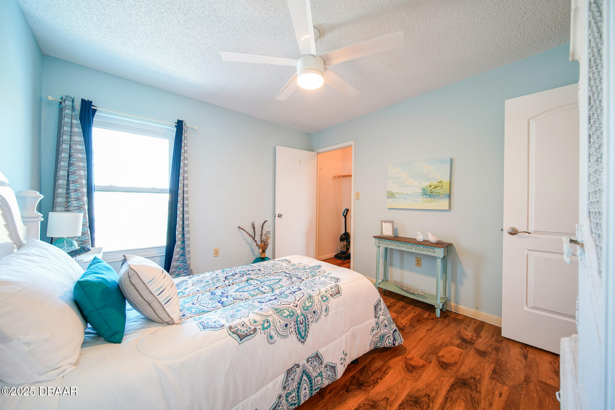 4590 South Atlantic Avenue, Unit 247 Ponce Inlet, FL 32127 - Photo 14 of 36 a bedroom with a large bed and a chandelier