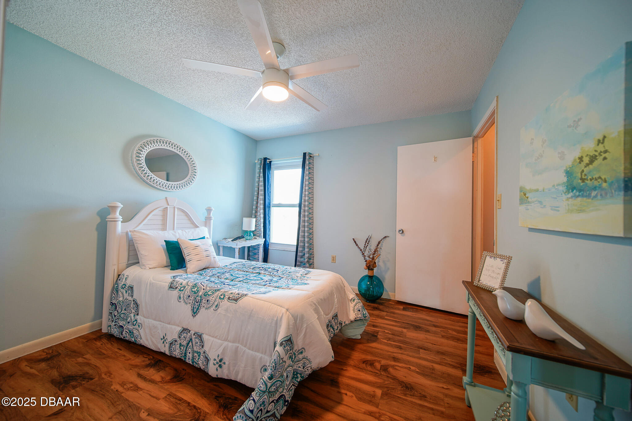 4590 South Atlantic Avenue, Unit 247 Ponce Inlet, FL 32127 - Photo 17 of 36 a bedroom with a bed and wooden floor