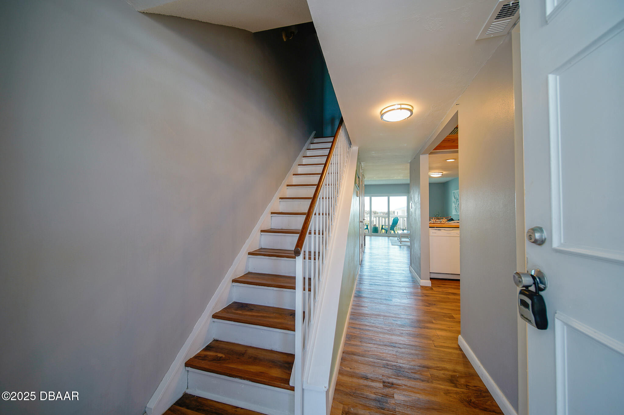 4590 South Atlantic Avenue, Unit 247 Ponce Inlet, FL 32127 - Photo 19 of 36 a view of a hallway with wooden floor and entryway
