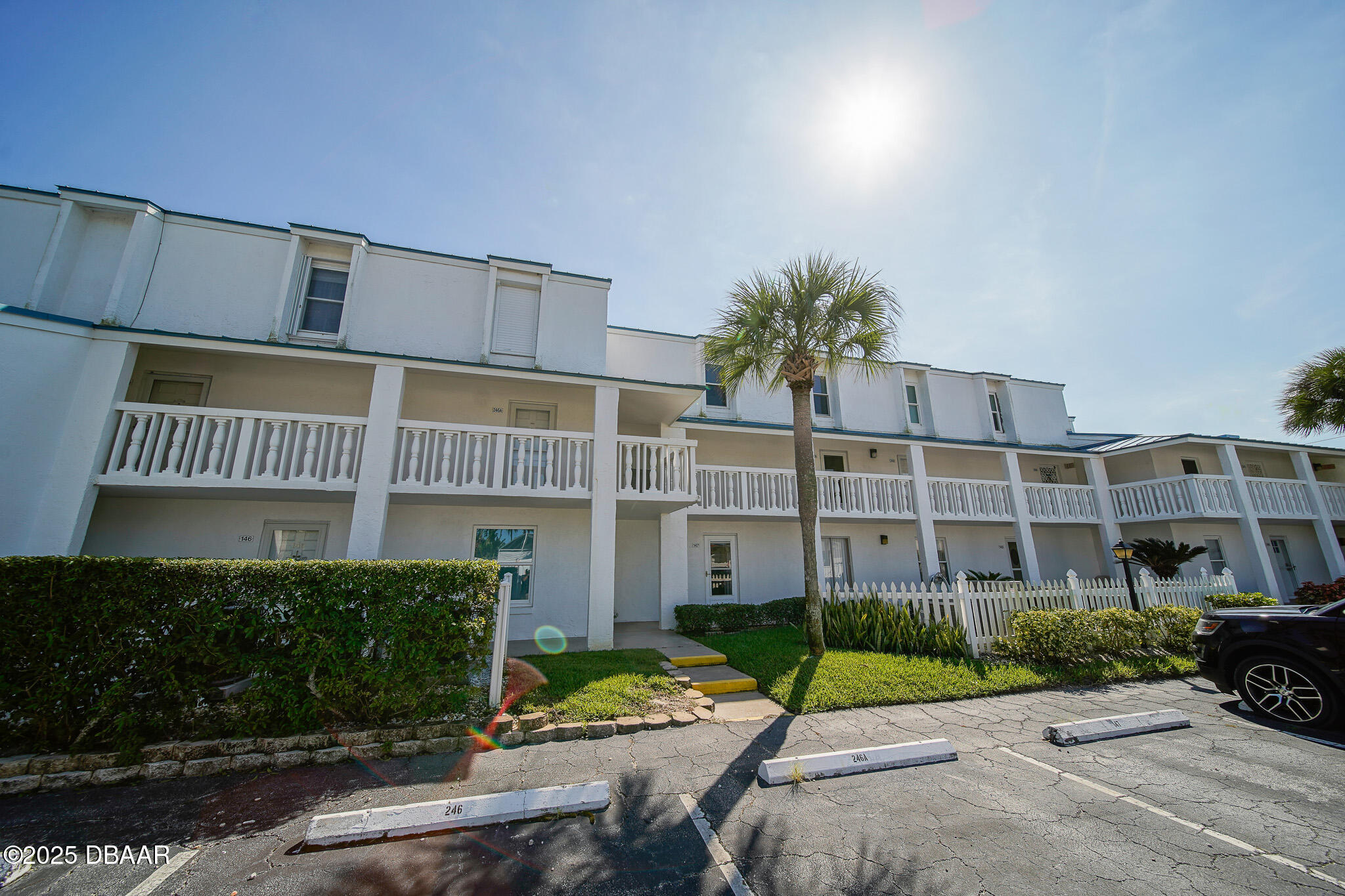 4590 South Atlantic Avenue, Unit 247 Ponce Inlet, FL 32127 - Photo 29 of 36 a view of a building with a yard and plants