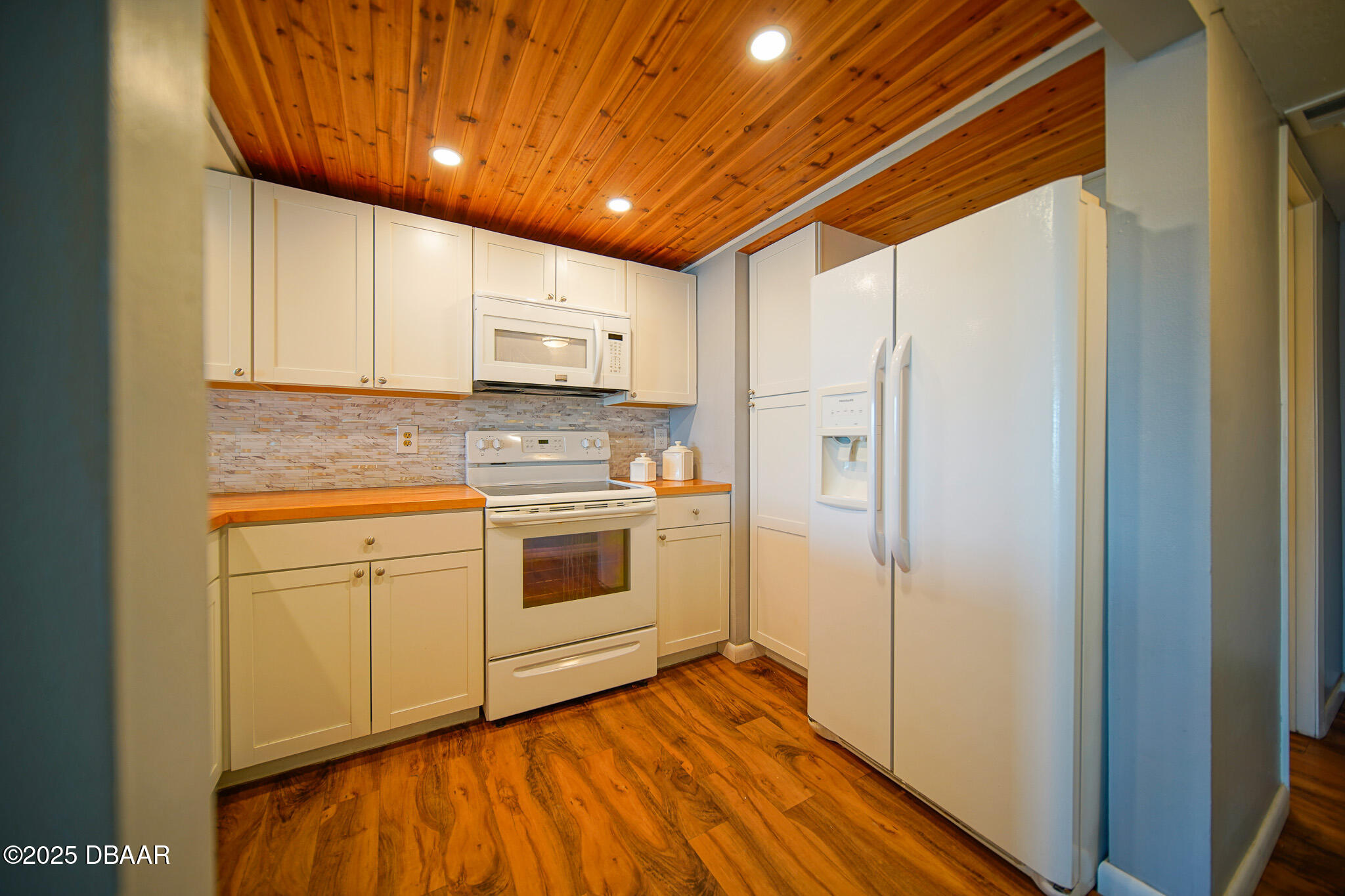 4590 South Atlantic Avenue, Unit 247 Ponce Inlet, FL 32127 - Photo 4 of 36 a kitchen with stainless steel appliances a stove sink and refrigerator
