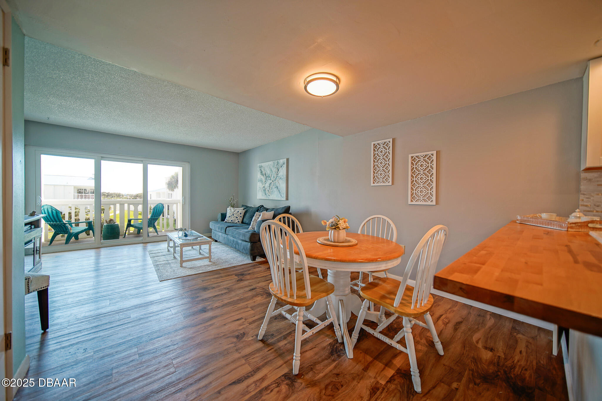 4590 South Atlantic Avenue, Unit 247 Ponce Inlet, FL 32127 - Photo 5 of 36 a dining room with furniture and wooden floor