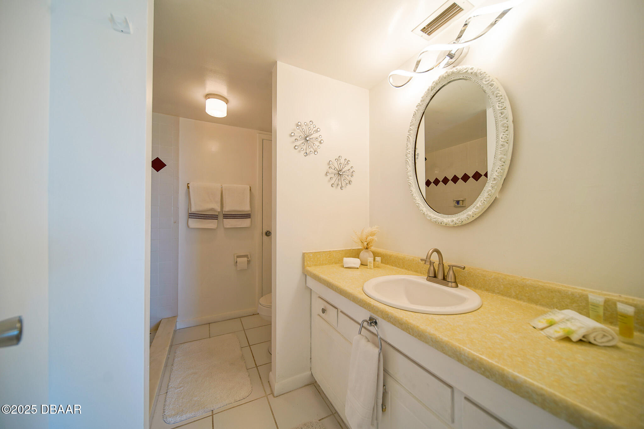 4590 South Atlantic Avenue, Unit 247 Ponce Inlet, FL 32127 - Photo 10 of 36 a bathroom with a granite countertop sink and a mirror