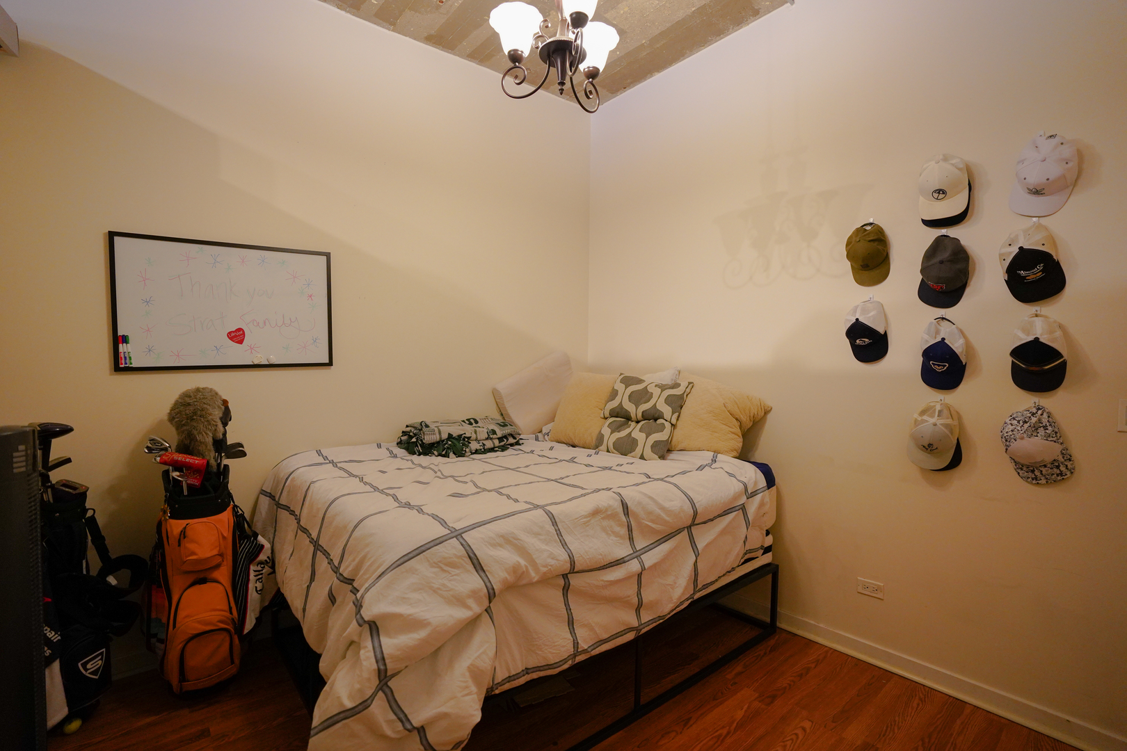 1069 West 14th Place, Unit 303 Chicago, IL 60608 - Photo 11 of 26 a bedroom with a bed and wooden floor